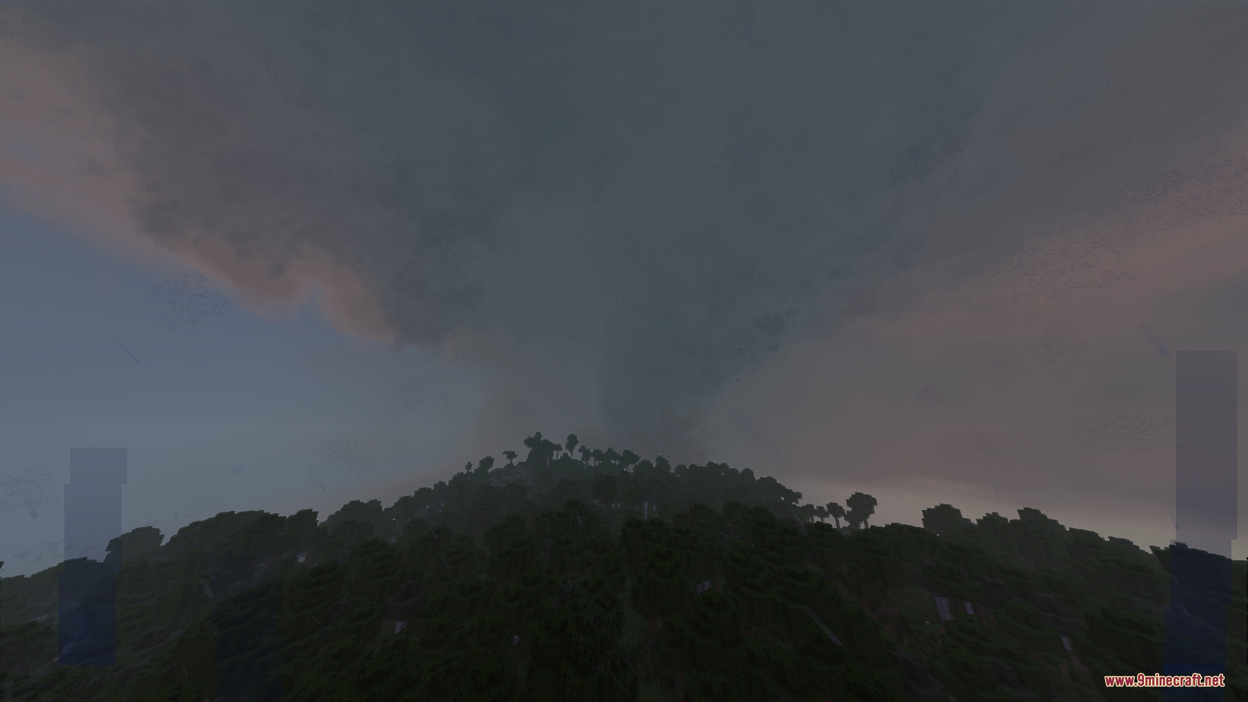 Autumn's Realistic Clouds Resource Pack Screenshot 8 A massive dark tornado forming over a forested hill in Minecraft