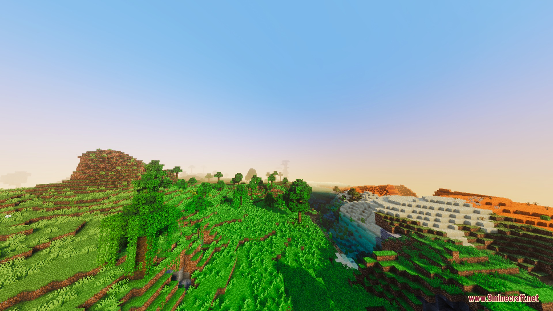 Bright daytime landscape featuring lush green hills and clear water in a valley