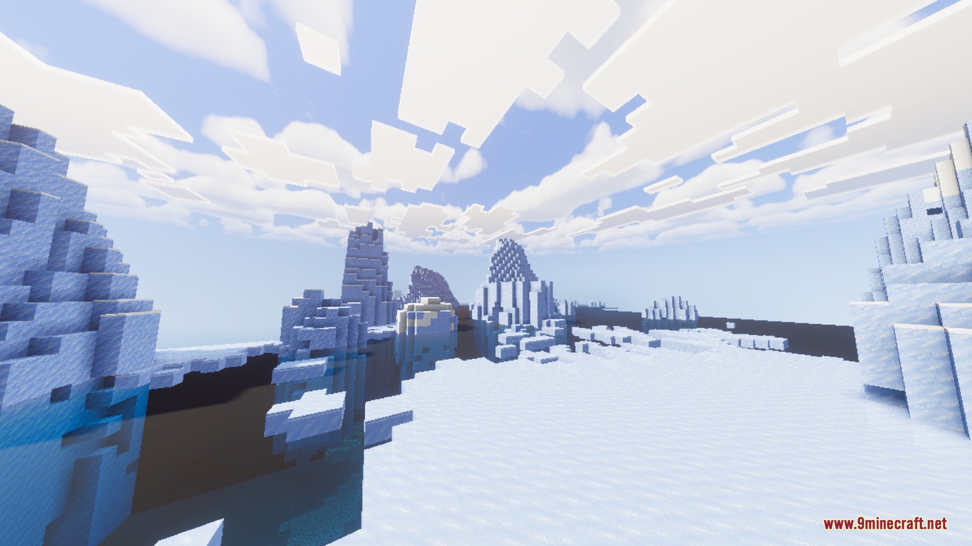 Icebergs and ice spikes floating in clear water under a bright blue sky