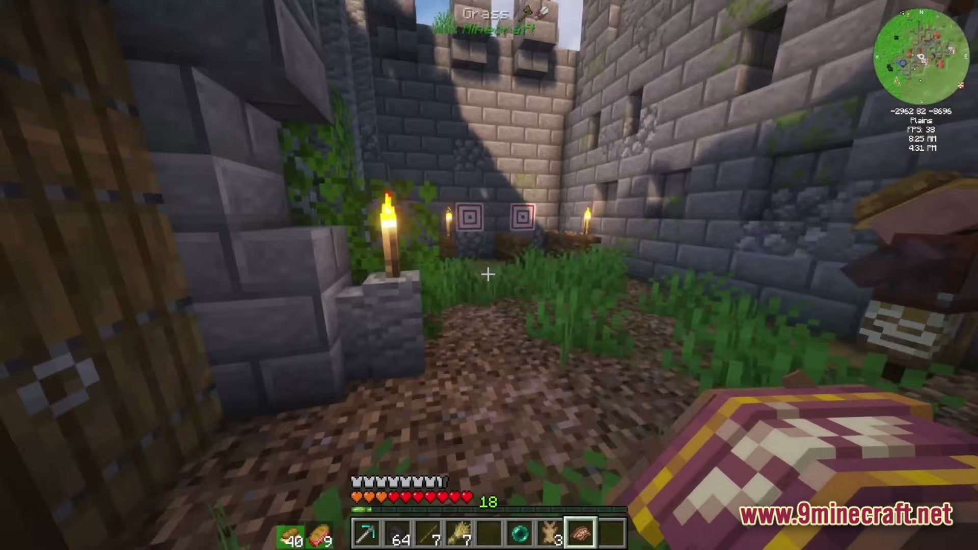 A stone brick courtyard featuring target blocks, torches, and a villager within a plains biome