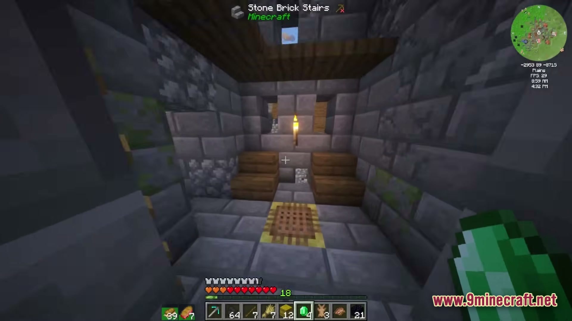 A player explores a stone brick interior featuring wooden stairs, a torch, and a decorative rug