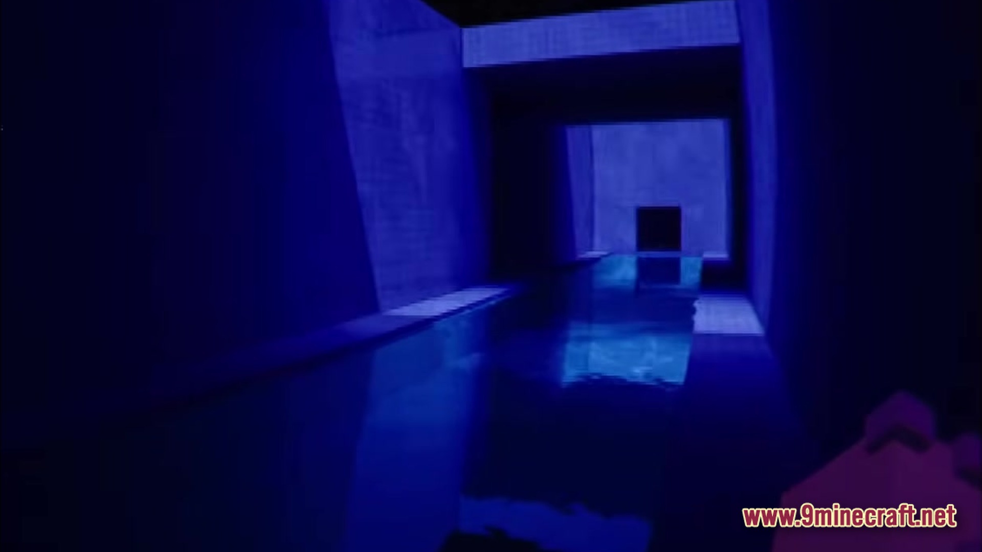 Backrooms Found Footage Modpack Screenshot 3 A dark, blue-lit indoor pool area with concrete walls and reflective water in a narrow corridor
