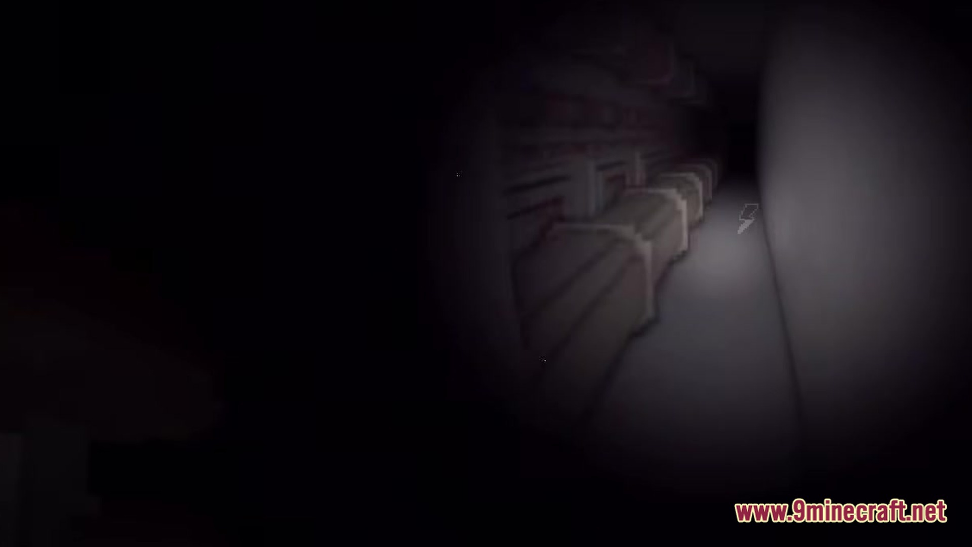 Backrooms Found Footage Modpack Screenshot 5 A dark industrial hallway illuminated by a flashlight featuring large pipes and a low battery icon