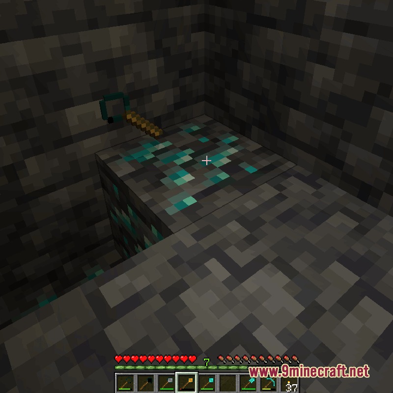 Balanced Ore Detector Mod Screenshot 3 A player uses a detector tool to find diamond ore deep underground