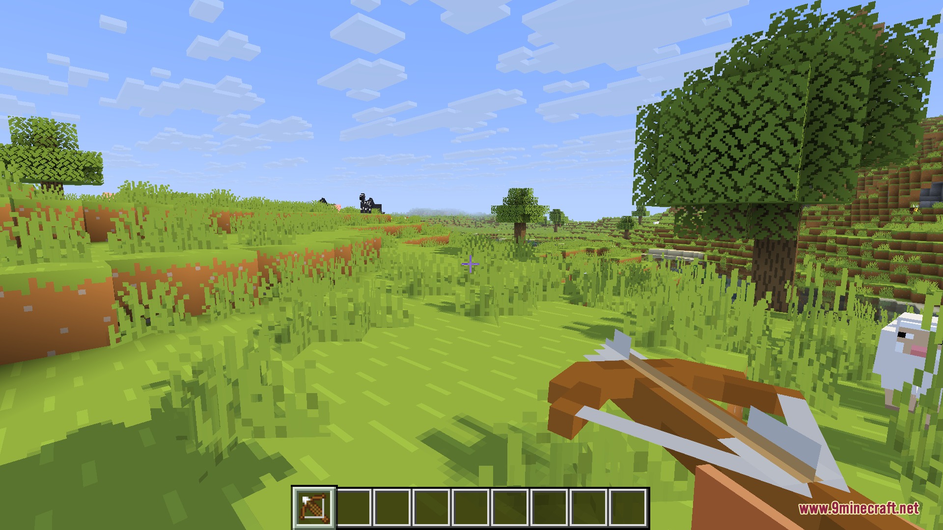 A player holding a blocky 3D crossbow in a simple grassy landscape