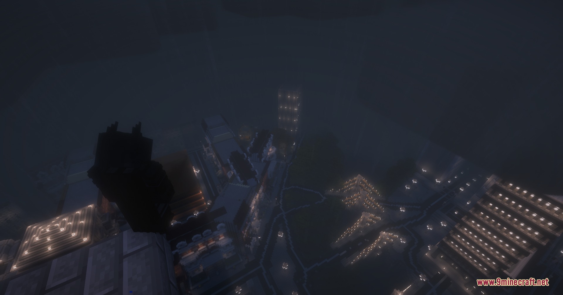 Batman by Yo Fadda Mod Screenshot 5 Batman overlooks a dark city at night with glowing lights and fog