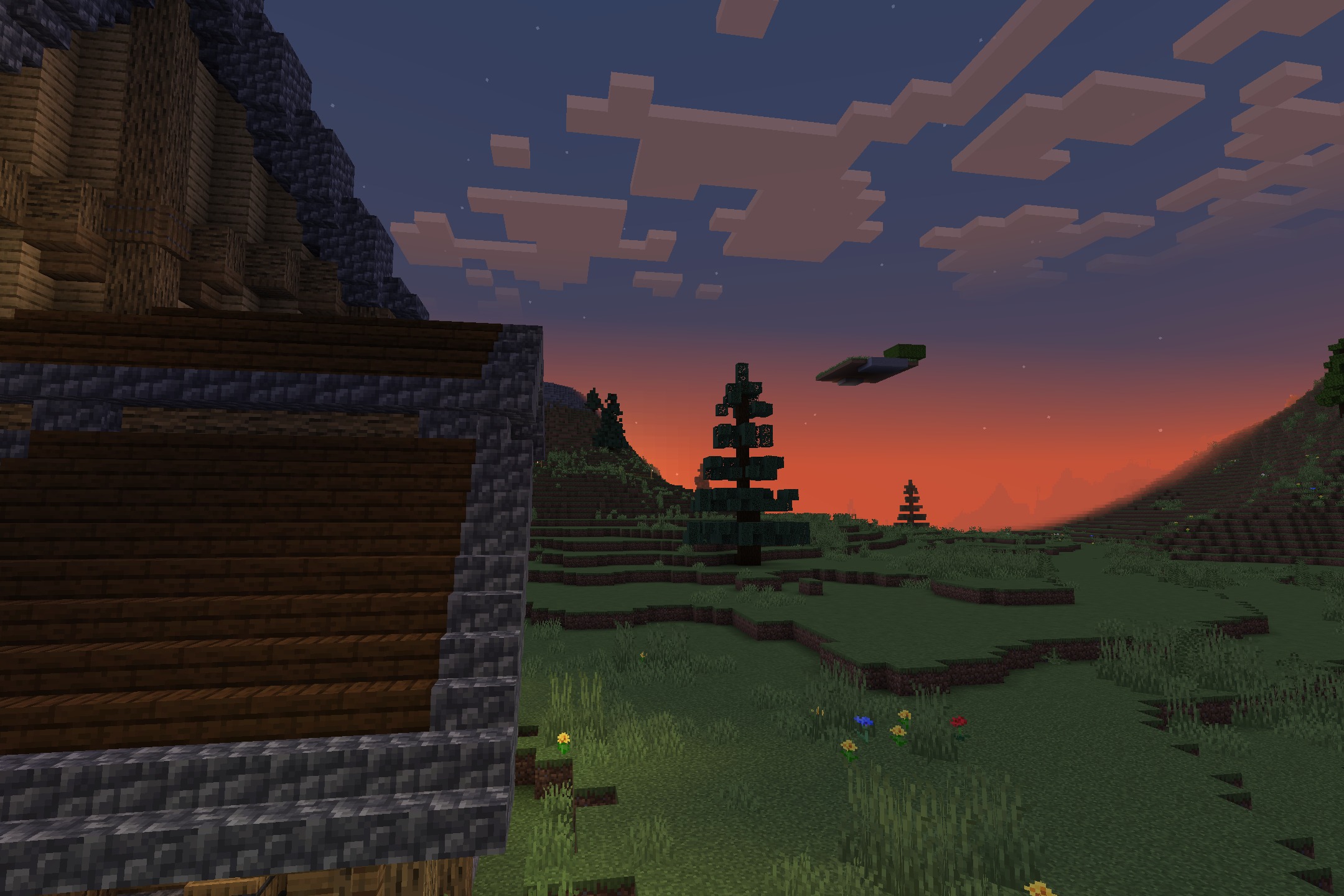 Bedrock Flavor Resource Pack Screenshot 10 A spruce tree in a grassy field during a vibrant orange sunset