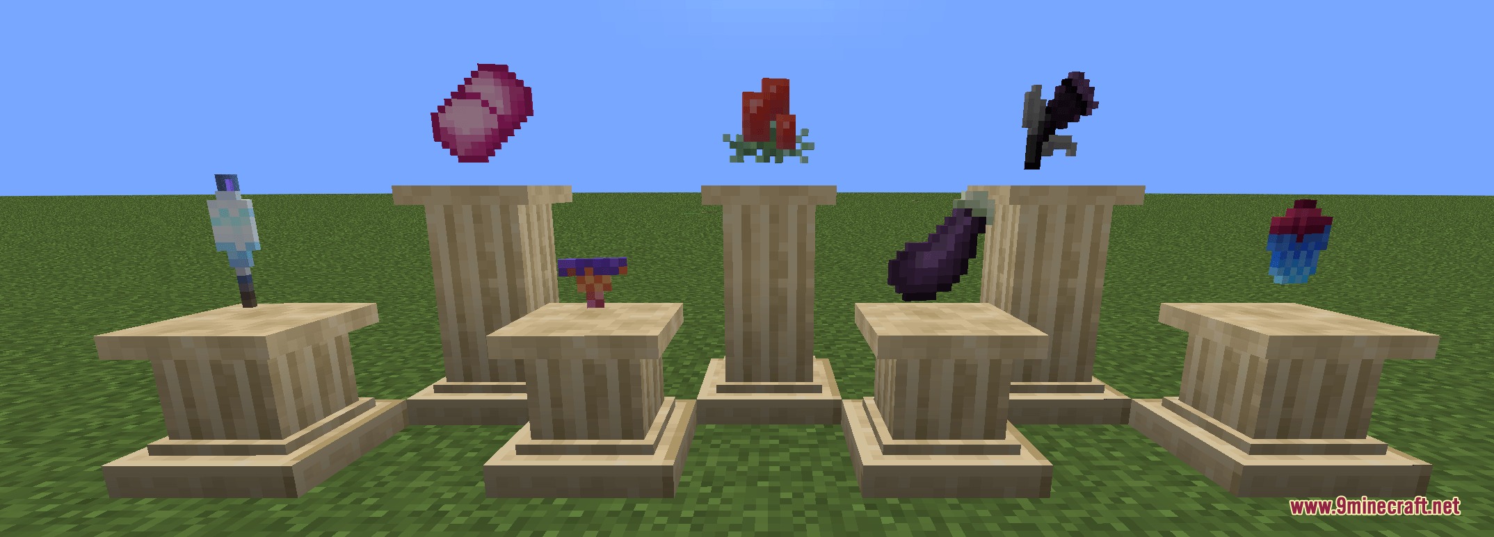 Various custom items and plants showcased on stone pillars in a grassy field