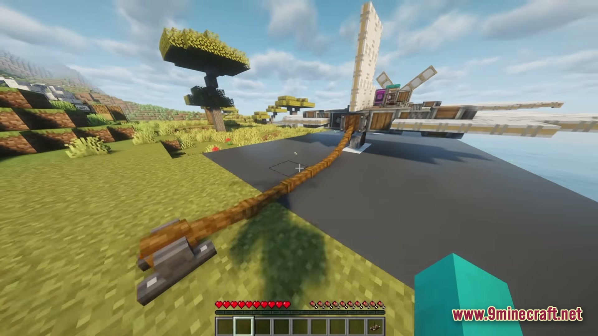 A mechanical aircraft is tethered to a ground anchor on a runway in a savanna biome