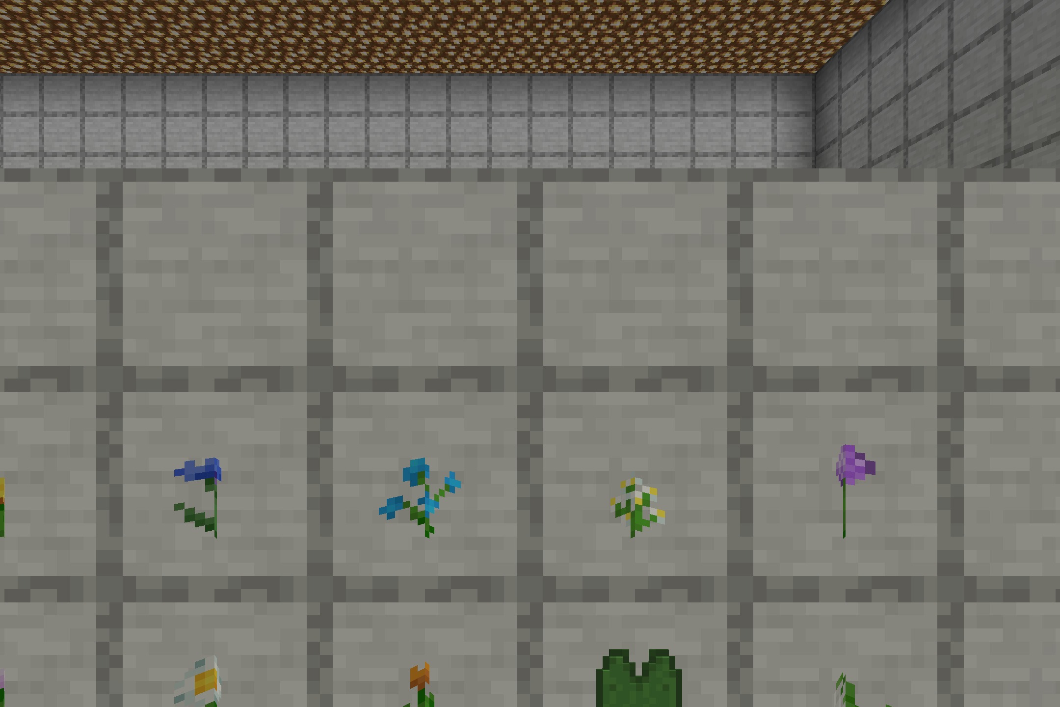 Close up view of flowers and a lily pad inside item frames on stone