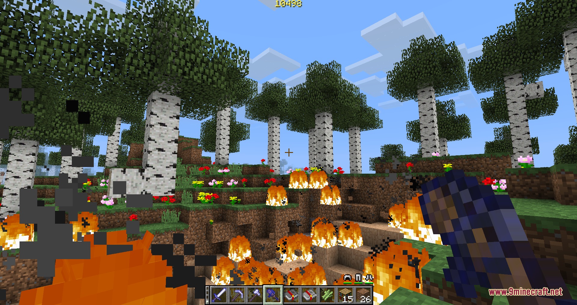 Better with Enchanting Mod Screenshot 2 Player holding an enchanted tool in a burning birch forest