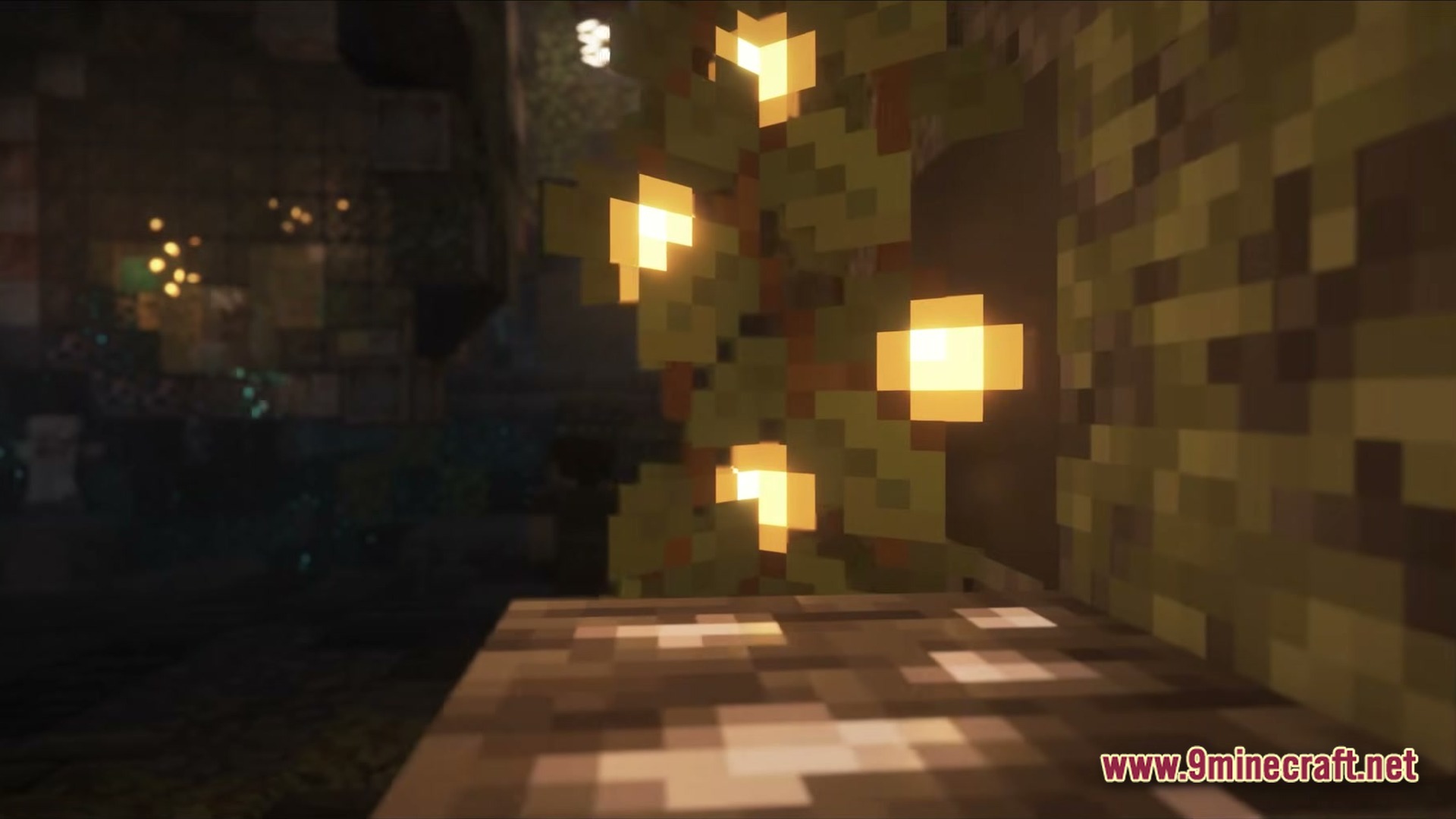 Glow berries hanging from a cave ceiling provide light in a dark underground environment