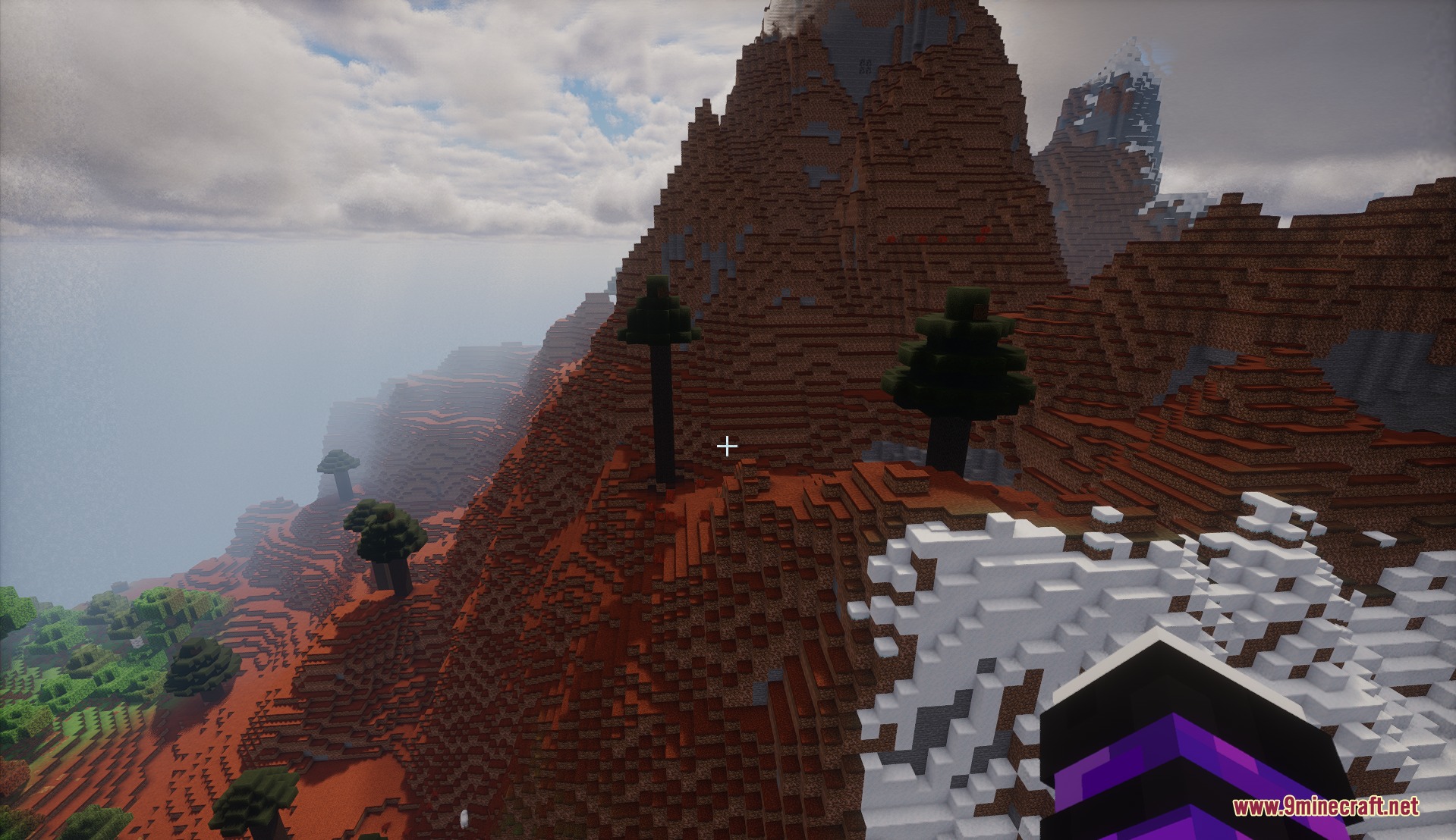 Biomes of Overworld Mod Screenshot 1 Player standing on a snowy cliff overlooking a massive brown volcano biome