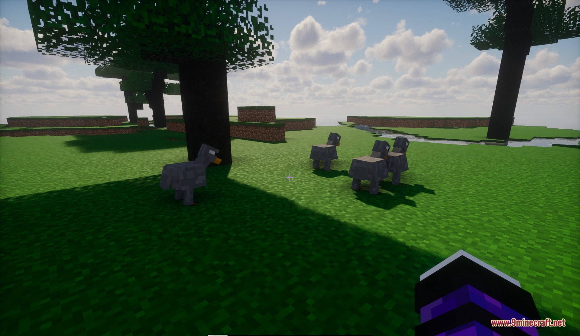 Biomes of Overworld Mod Screenshot 3 Several grey dodo birds standing on a grassy field near a large tree
