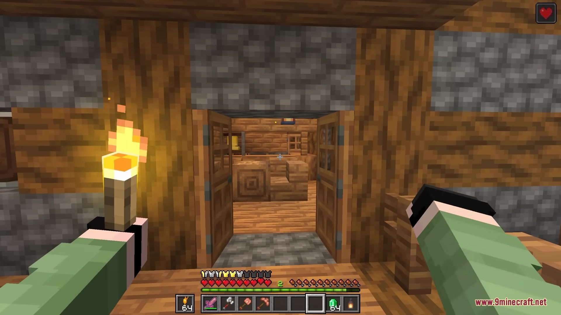 Bits and Balance Mod Screenshot 10 A player holds a torch while looking through open doors inside a house