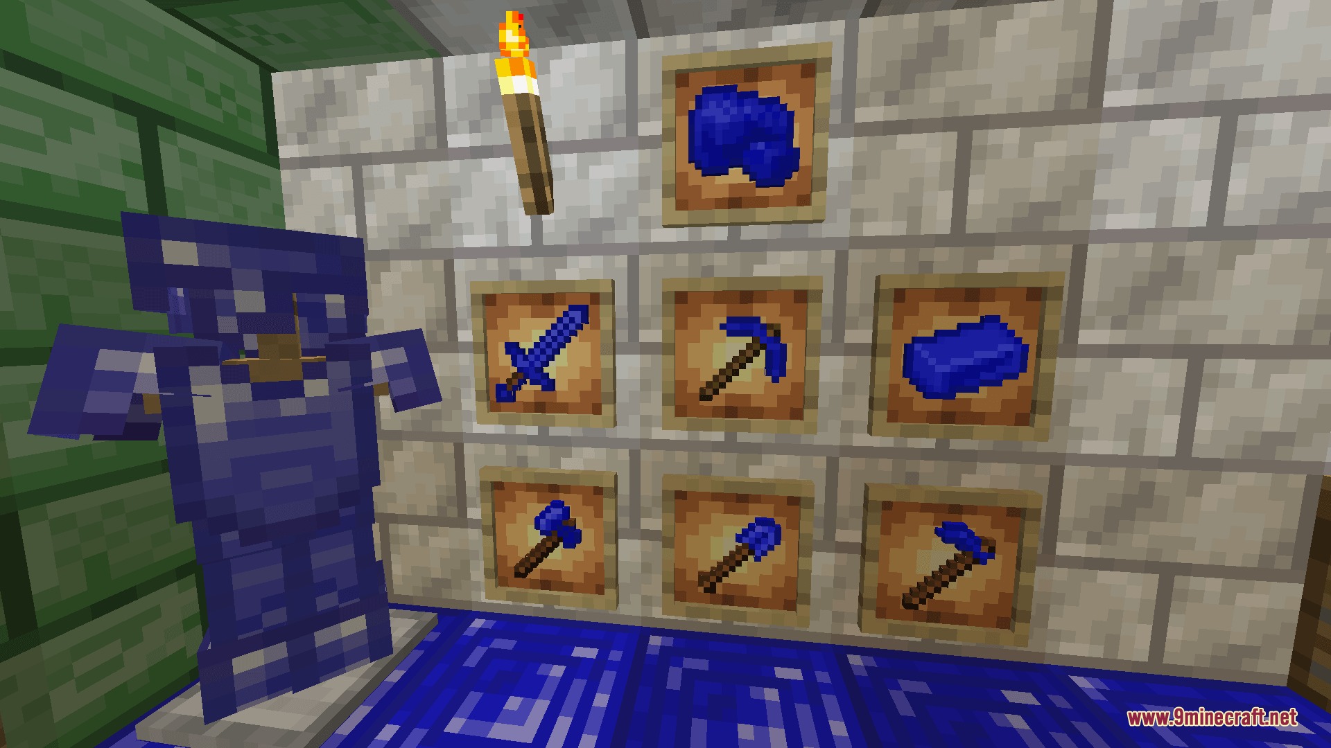 Blue cobalt armor and tools displayed on a stone brick wall