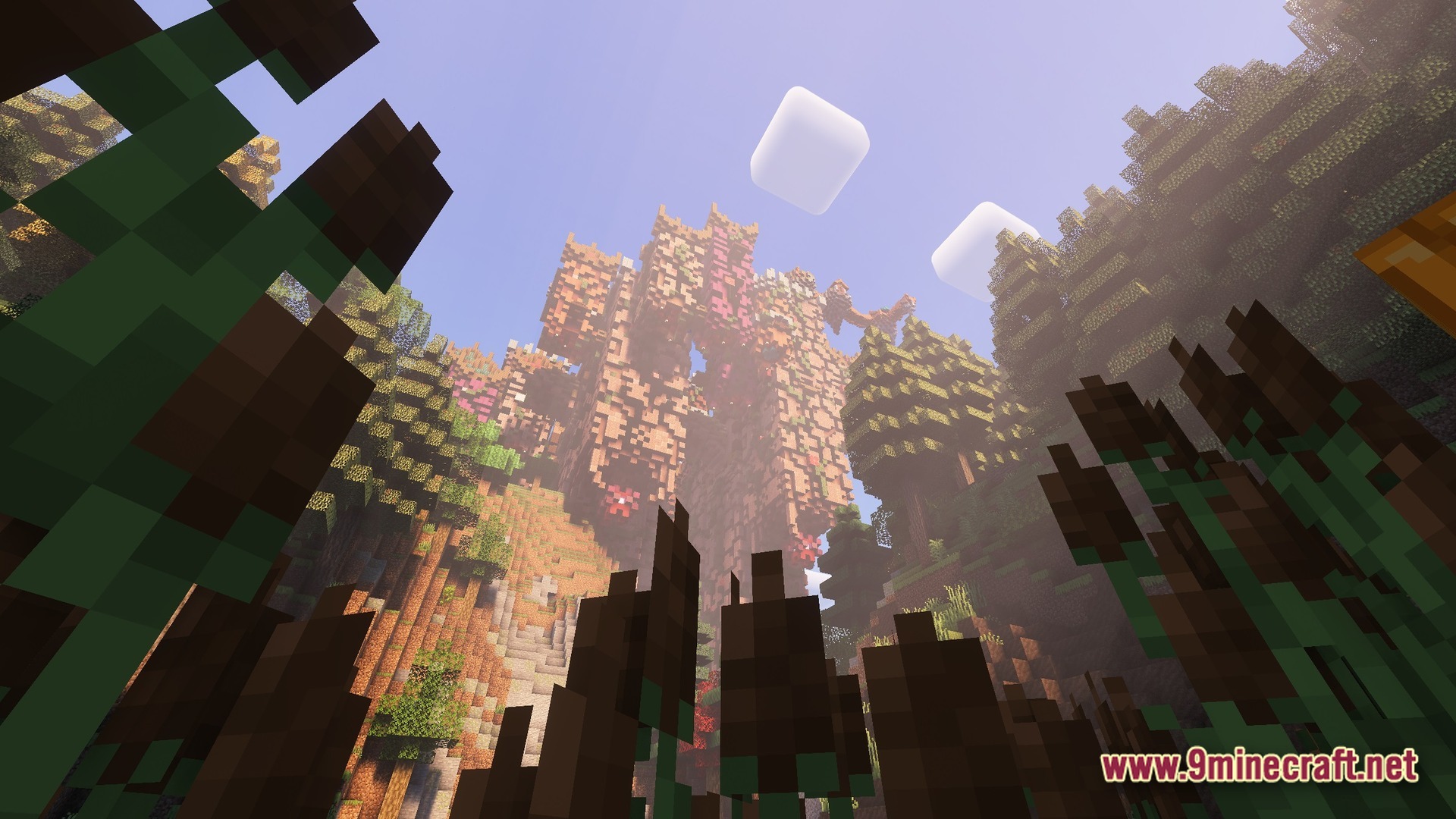 Boundless Tale Odyssey Modpack Screenshot 7 A large stone structure covered in vines and flowers towers over a forested valley landscape