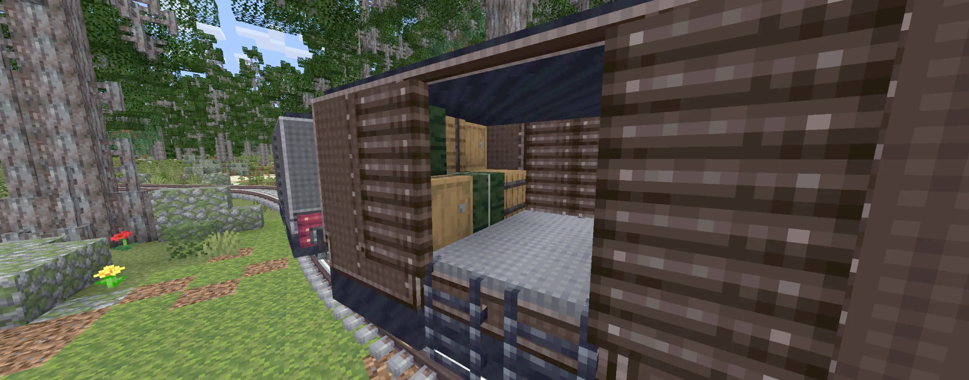 The interior of a wooden train car filled with crates and storage items