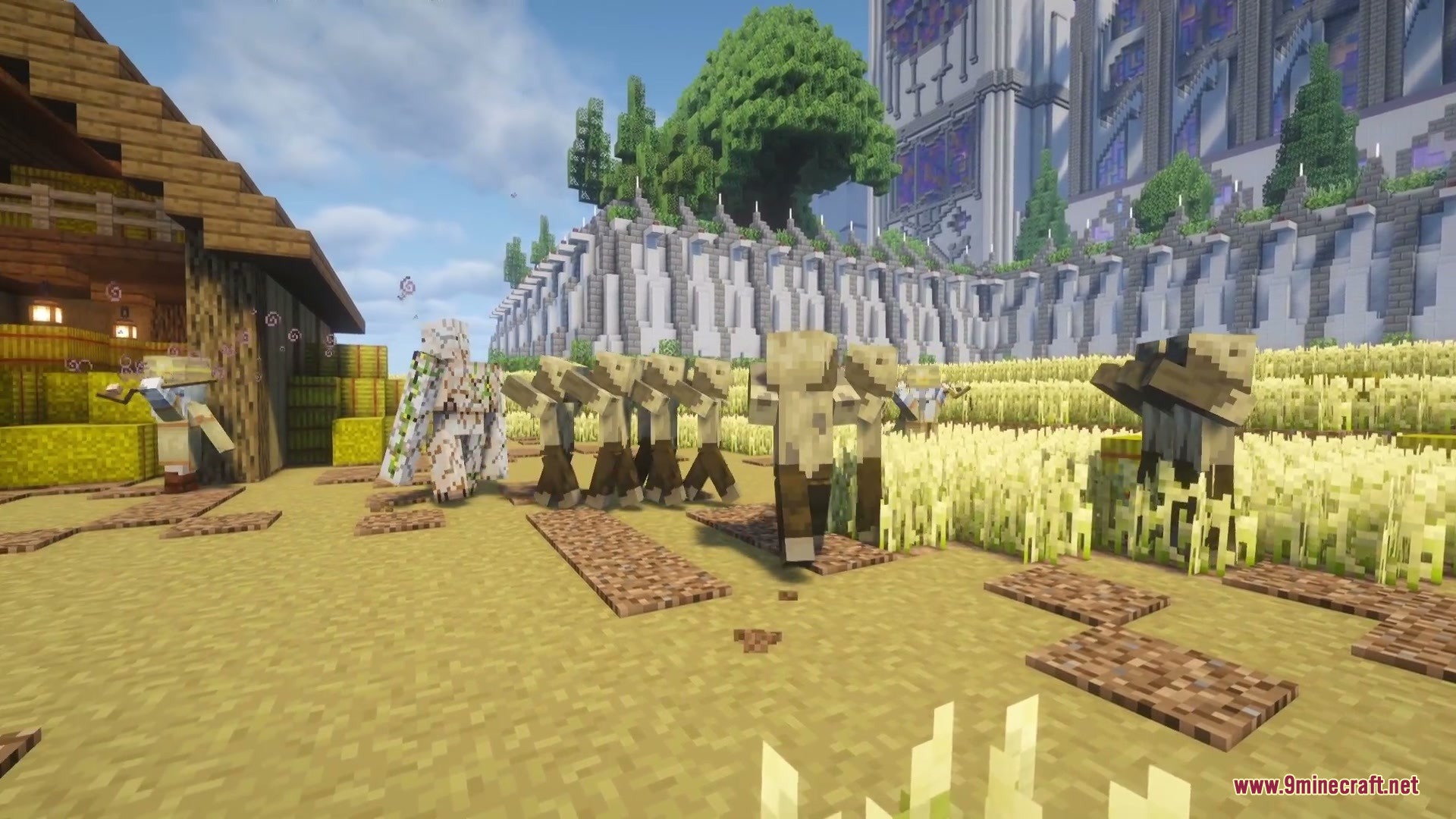 Husks wandering through a wheat field near an iron golem and a villager