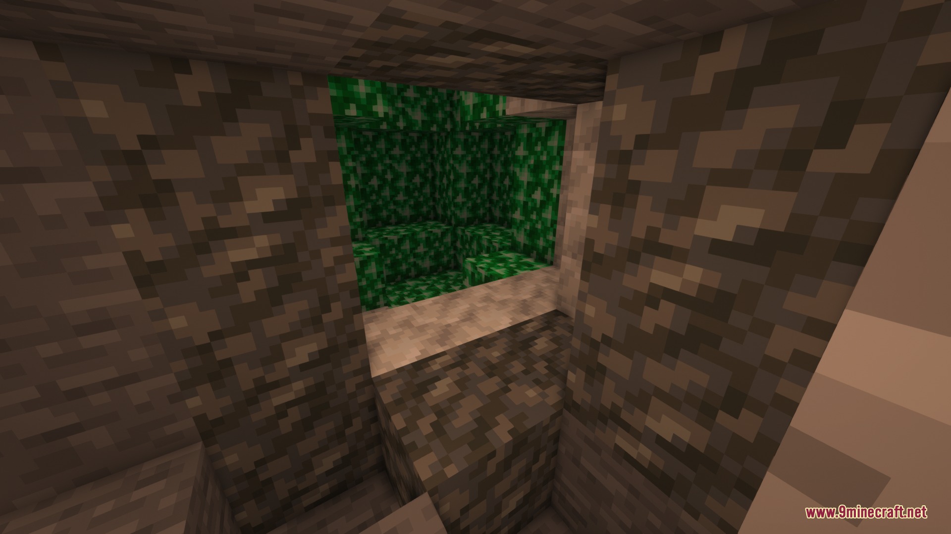 Bricks N' Blocks Mod Screenshot 1 A cluster of emerald blocks hidden behind a stone wall in a cave