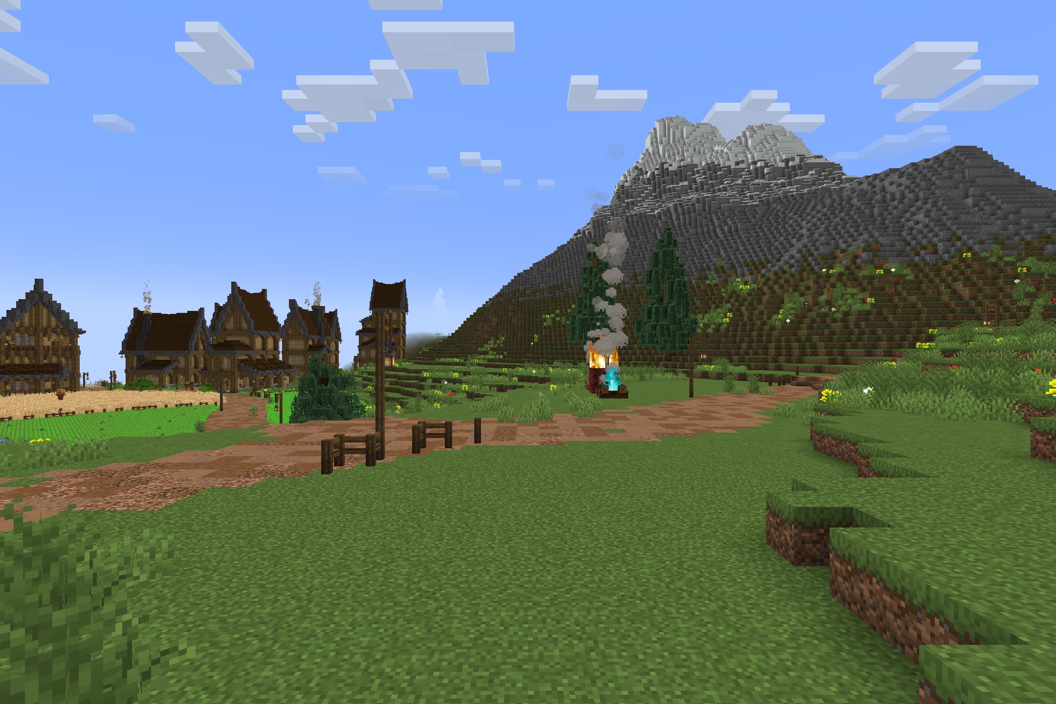 BwW Resource Pack Screenshot 1 Rustic medieval village with a dirt path and campfire near a snowy mountain