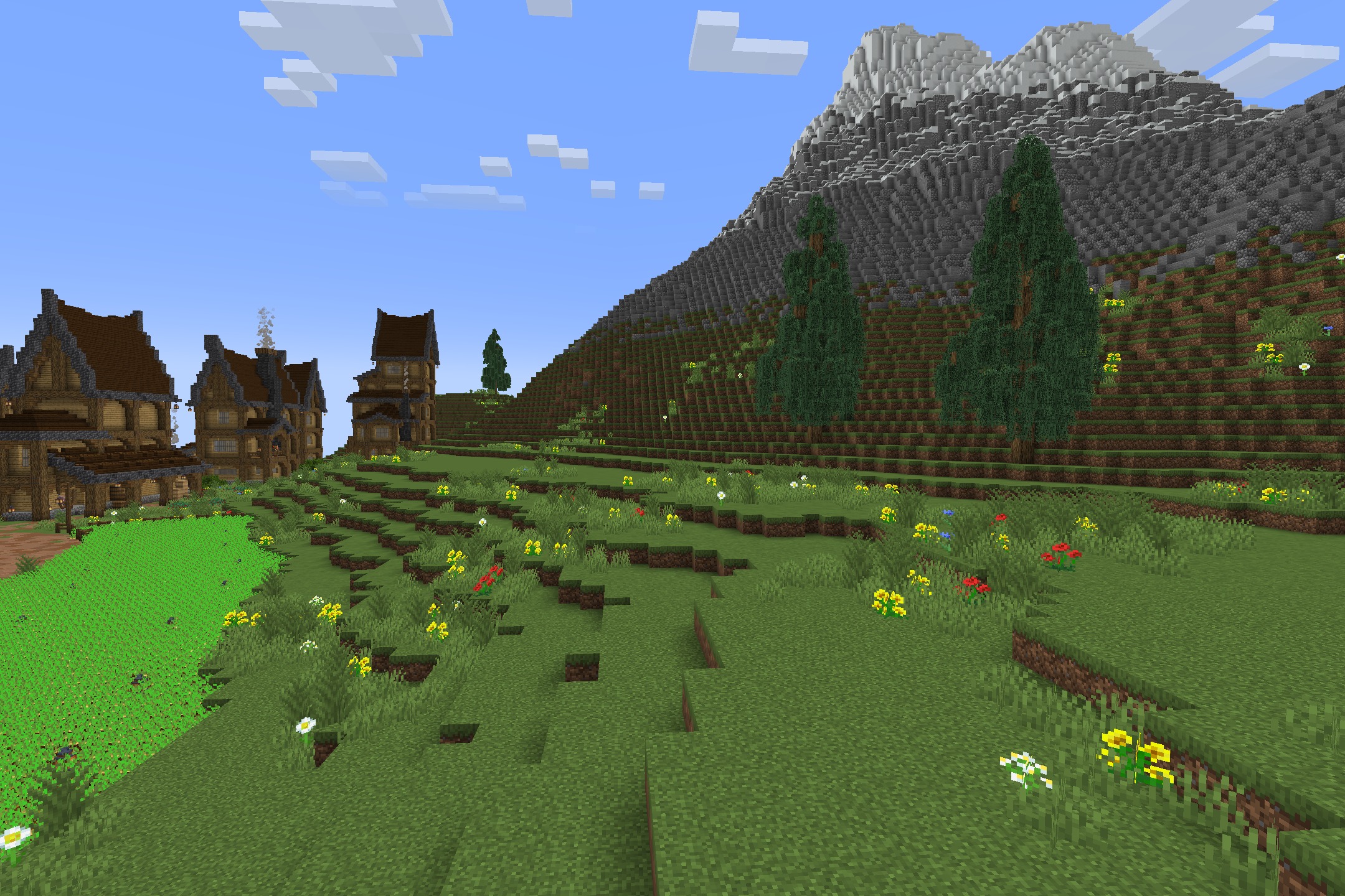 BwW Resource Pack Screenshot 2 Flowery green hills leading to a cozy medieval village at the mountain base