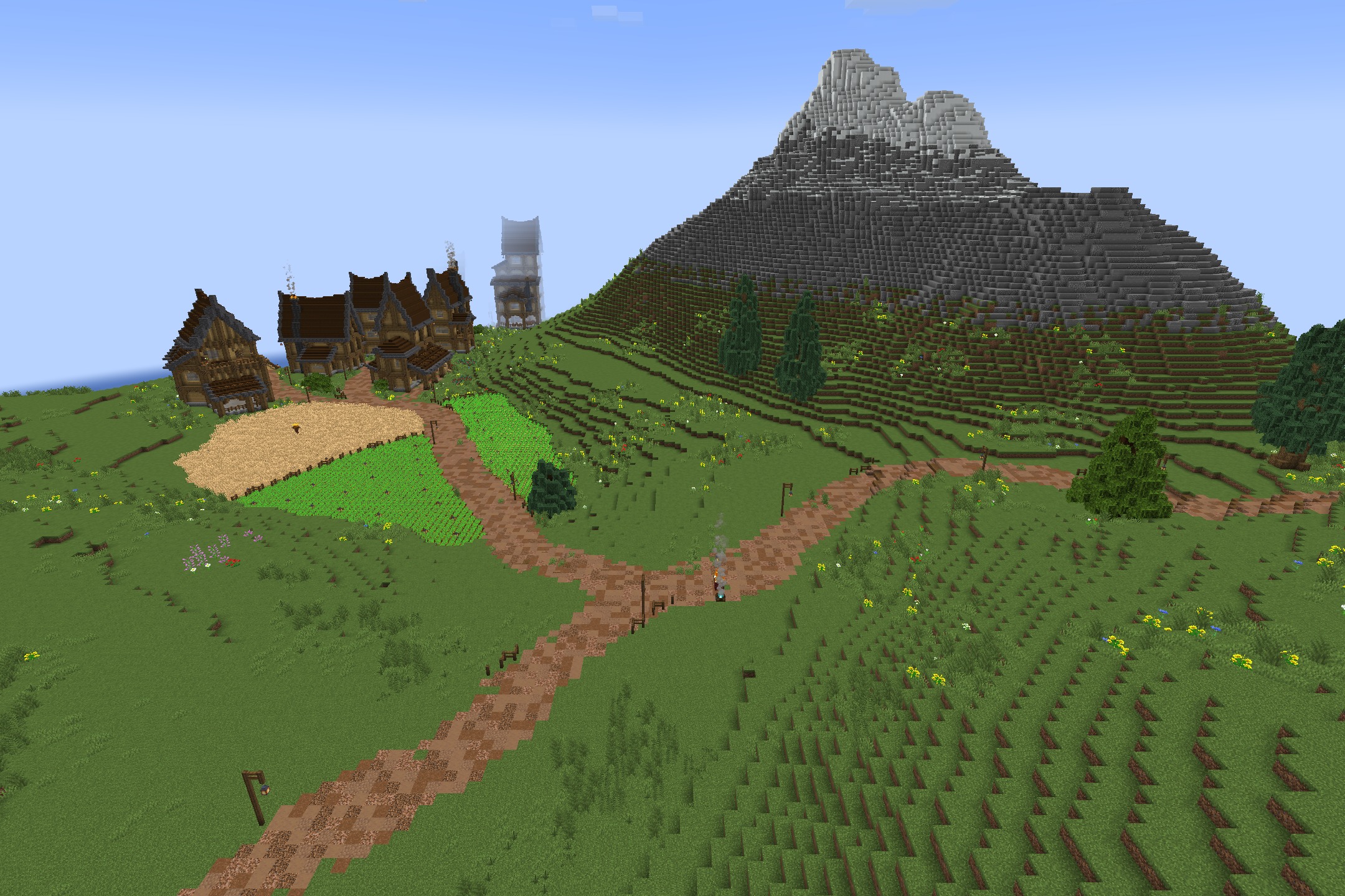 BwW Resource Pack Screenshot 6 A cozy medieval village with rustic houses and wheat fields near a mountain