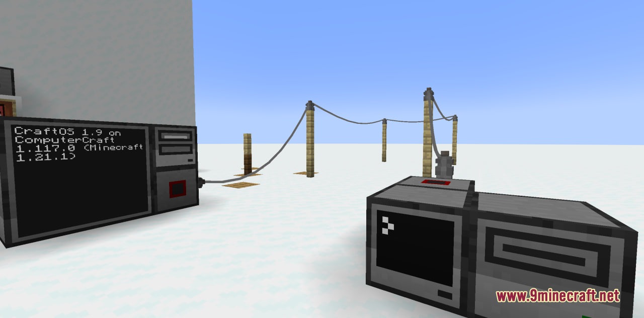 Long distance network cables connecting two computers across a snowy field using poles