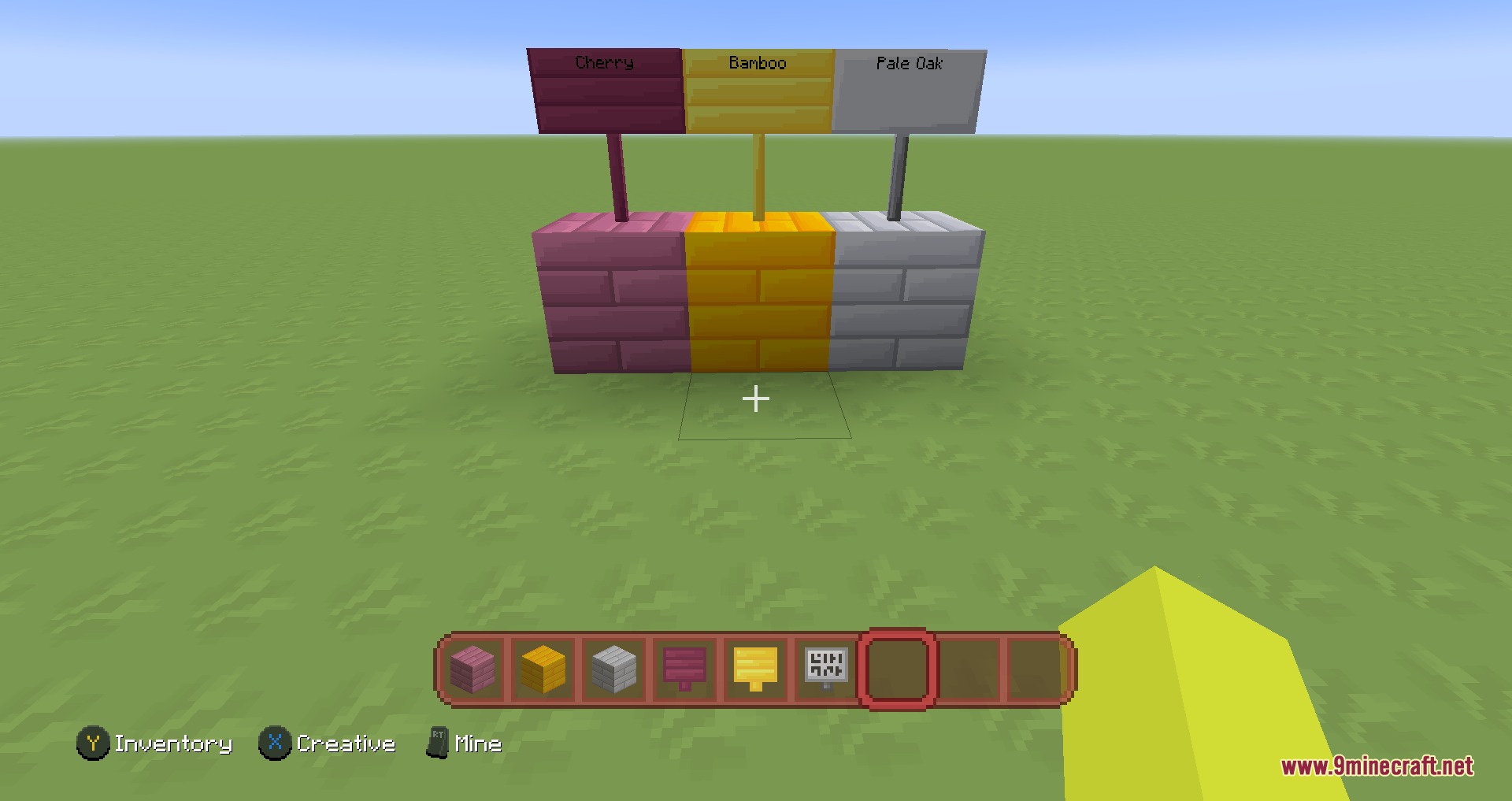 Cartoon Texture Concept Update 1.20 Resource Pack Screenshot 3 Display of Cherry Bamboo and Pale Oak wood blocks with matching hanging signs