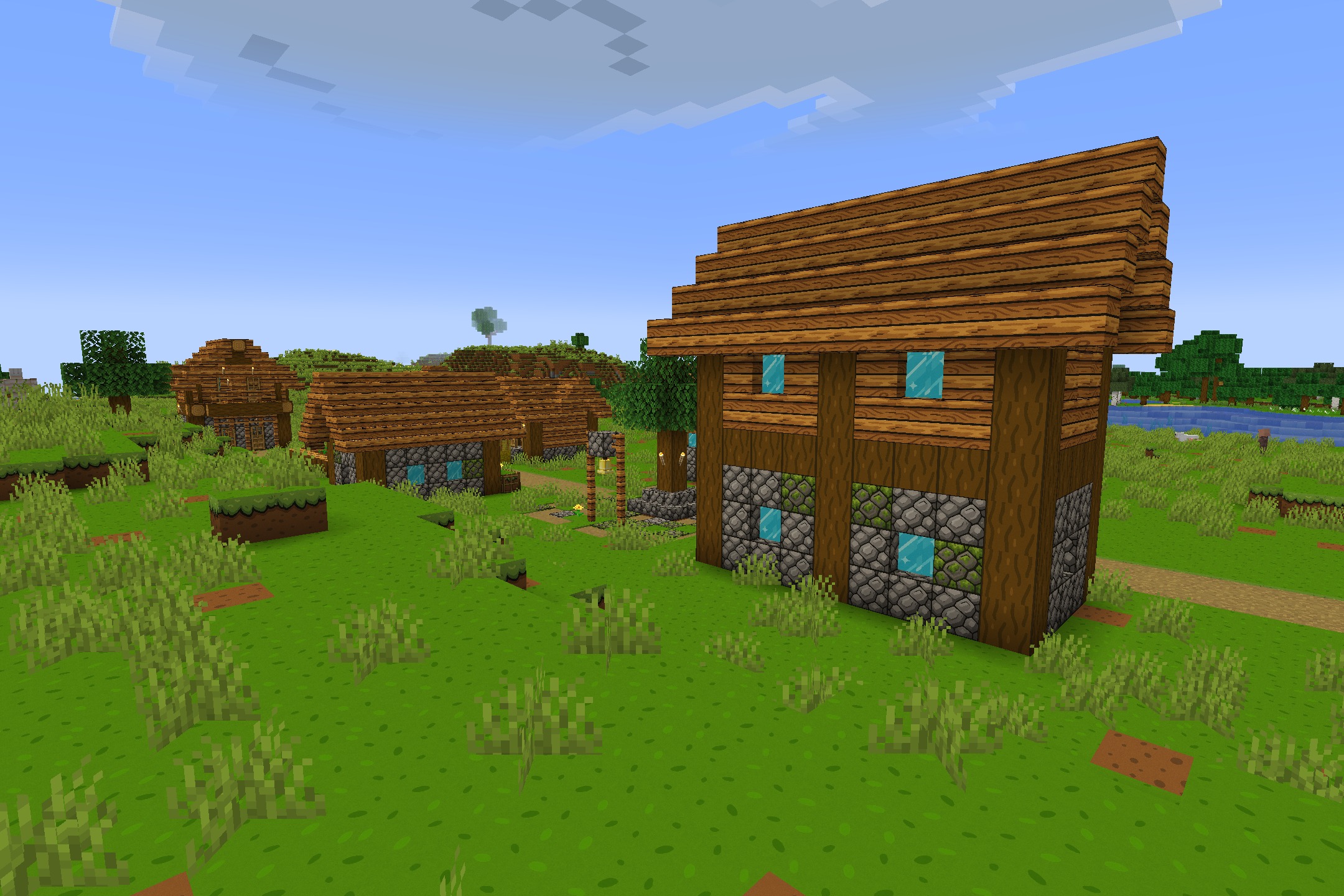 CartoonCraft Resource Pack Screenshot 3 Brightly colored wooden houses in a village with simple hand drawn textures