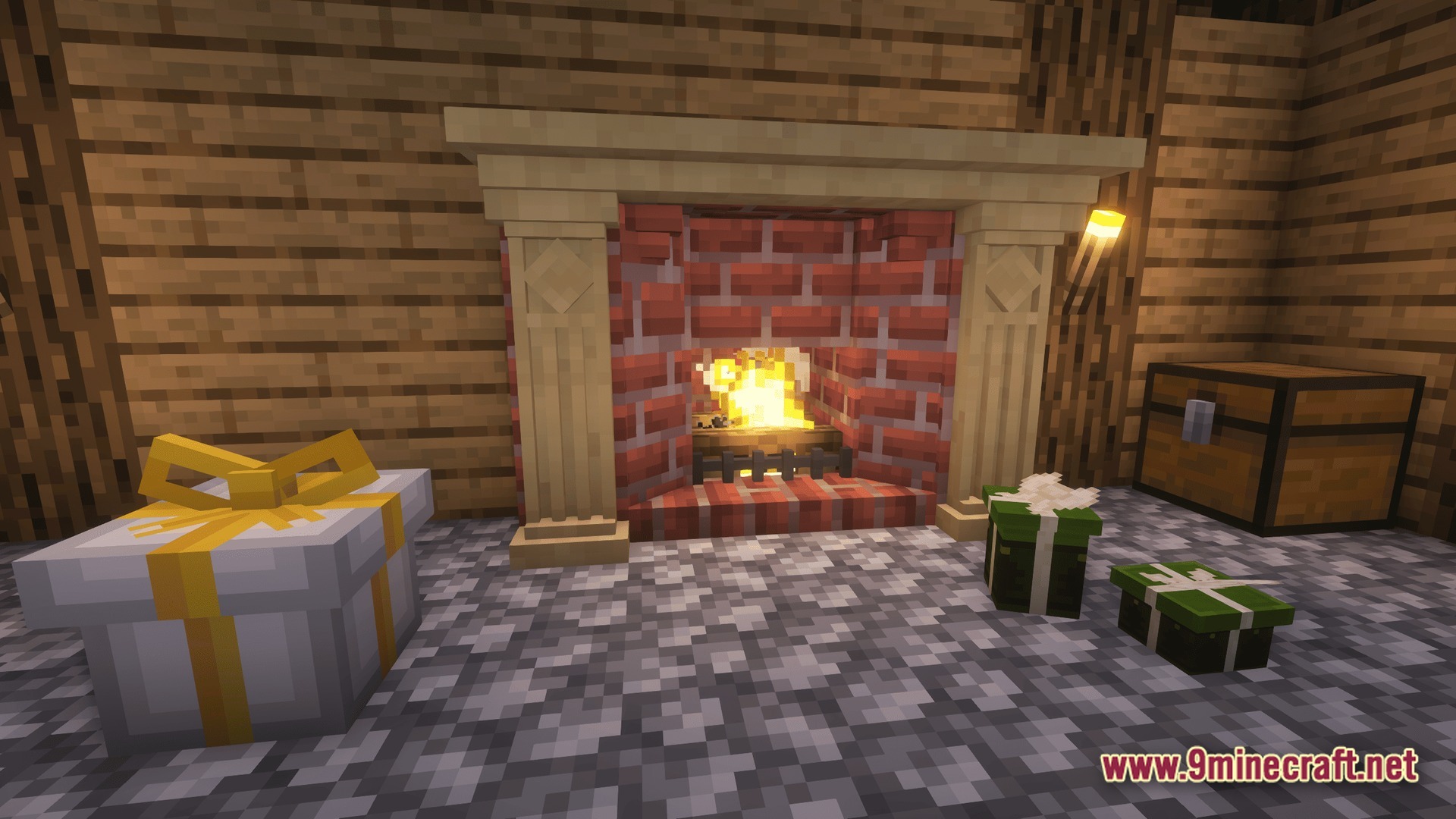 A brick fireplace with a lit fire surrounded by various wrapped gift boxes and a chest