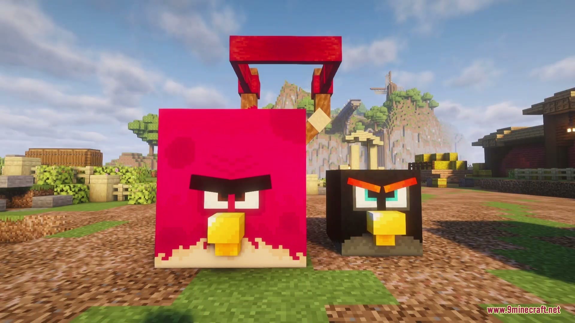 Red and black bird characters standing on the ground near a slingshot