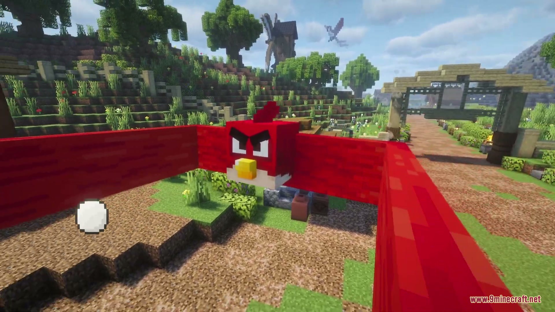 A red bird character being launched from a large slingshot in Minecraft