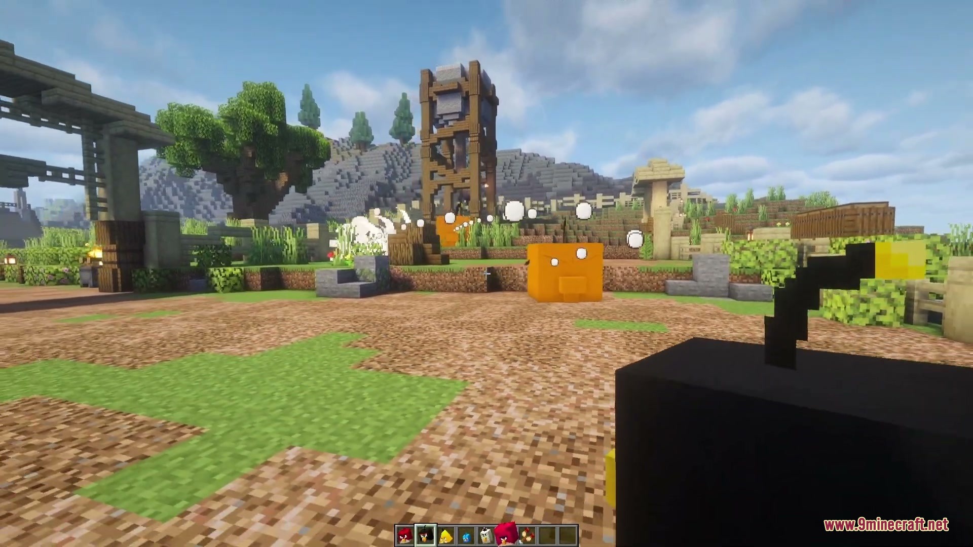 Player holding a black bomb bird while a wooden tower collapses nearby