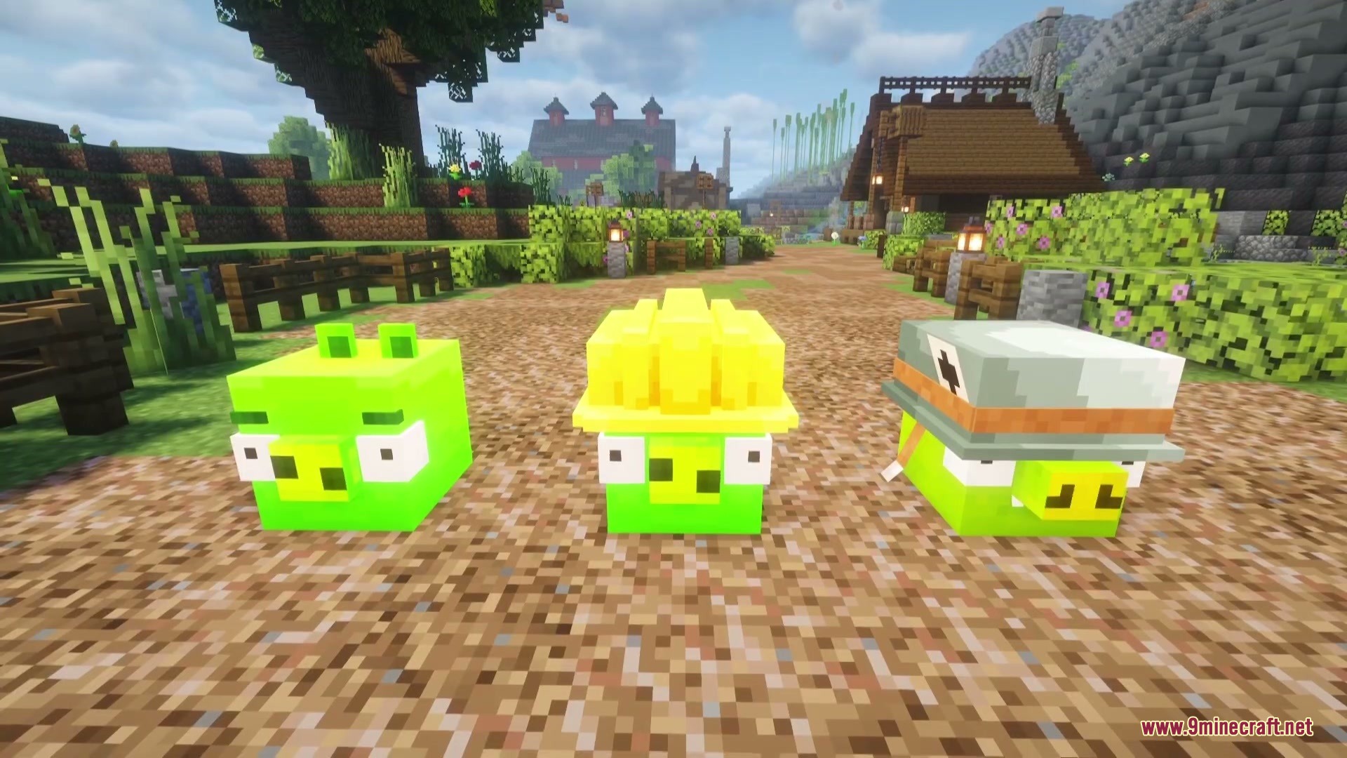 Three green pigs wearing different hats standing on a dirt path