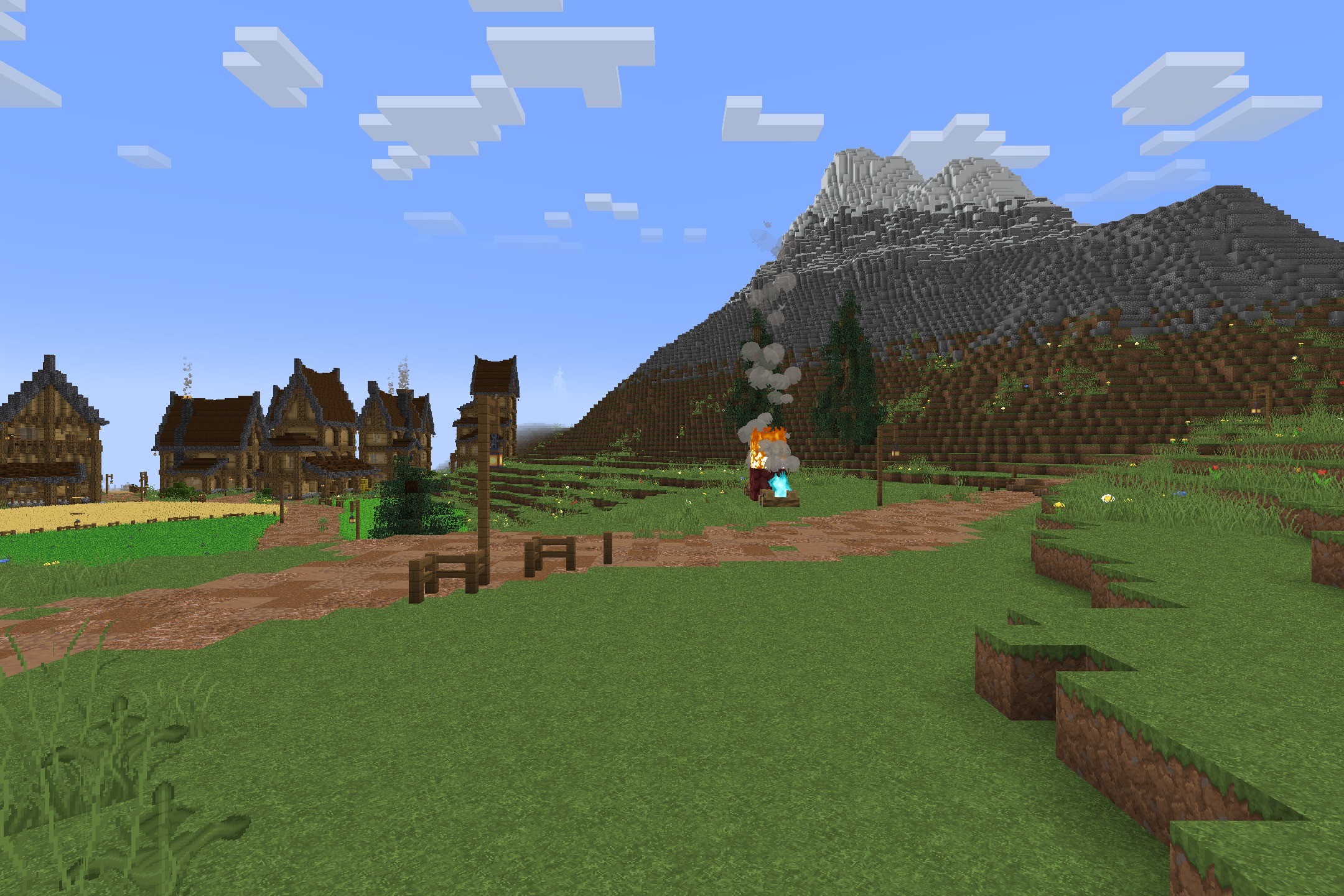Classic Faithful 64x Jappa Resource Pack Screenshot 2 A peaceful village with wooden houses and a campfire near a large mountain
