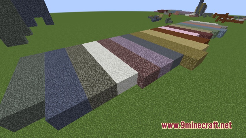 A long row of diverse cobbled stone blocks placed on green grass