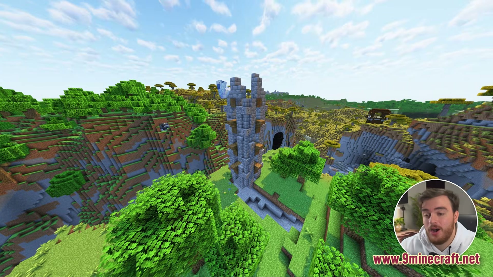 Cobblemon Eternal The Minecraft Pokémon Experience Modpack Screenshot 4 A tall stone brick tower stands within a lush green valley surrounded by forested hills
