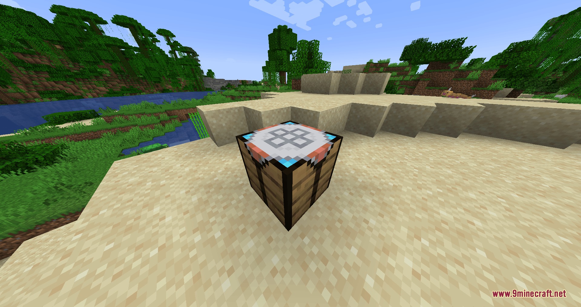 The Modular Ball Workbench block sitting on sand near a lush jungle biome