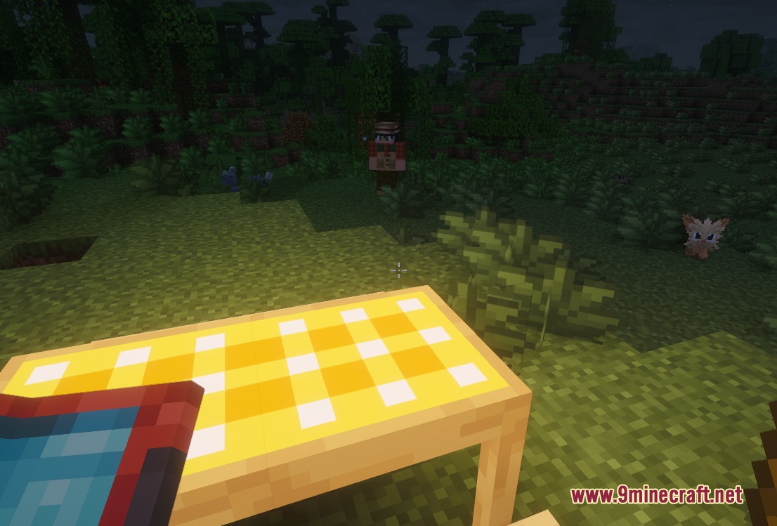 Cobblemon Picnic Mod Screenshot 3 A yellow checkered picnic table placed in a forest with wild Pokemon