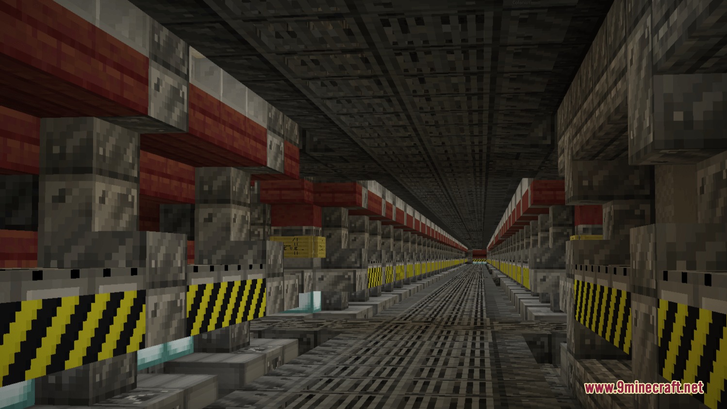 A long industrial hallway featuring metallic blocks and yellow hazard warning stripes