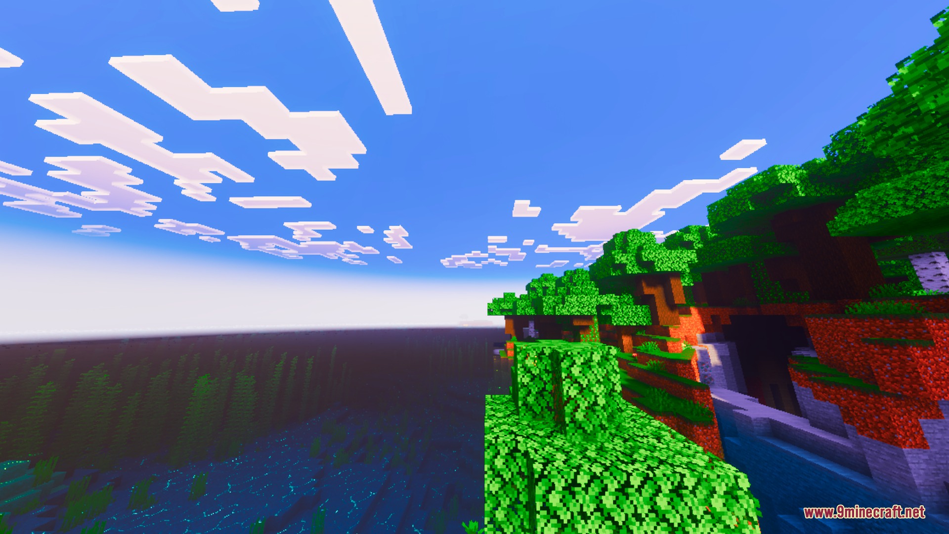 Colorful Visuals Shader Screenshot 2 Lush green foliage on a cliff overlooking a highly saturated blue Minecraft ocean