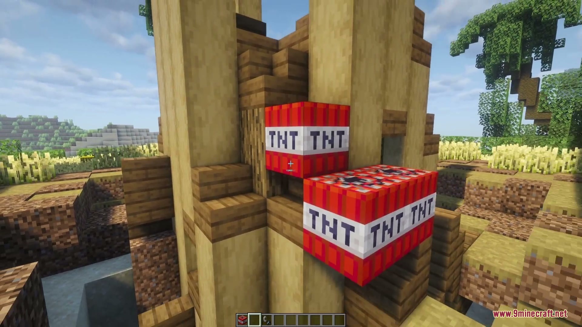 Combustive Ordnance Expansion Mod Screenshot 3 A player placing TNT blocks on a wooden tower in a Minecraft world