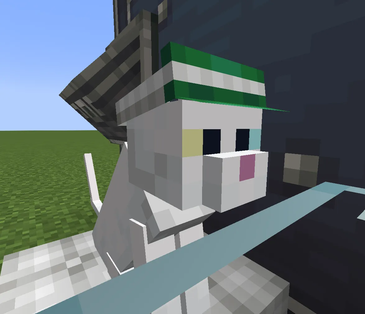Close up view of a white cat wearing a green striped hat