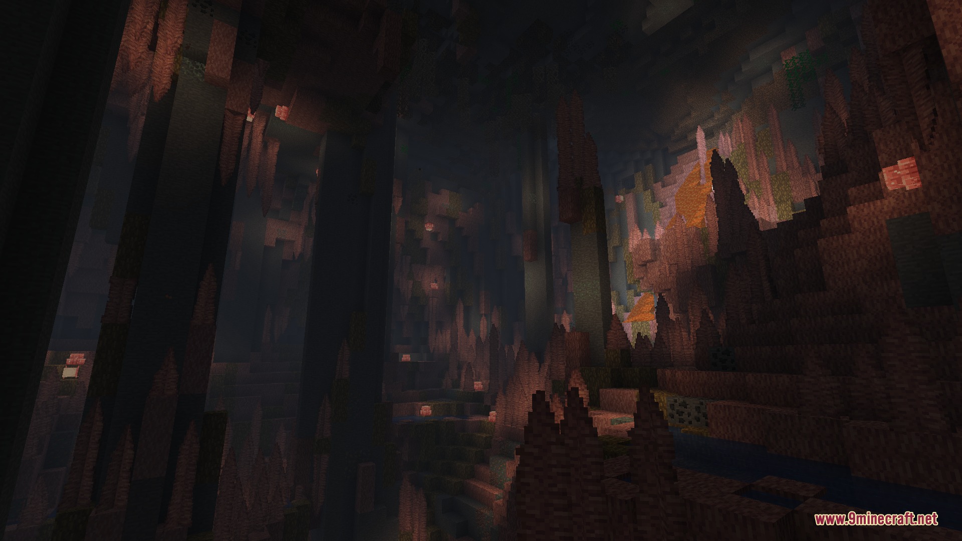 Large underground cavern with tall rock pillars and warm glowing orange lights