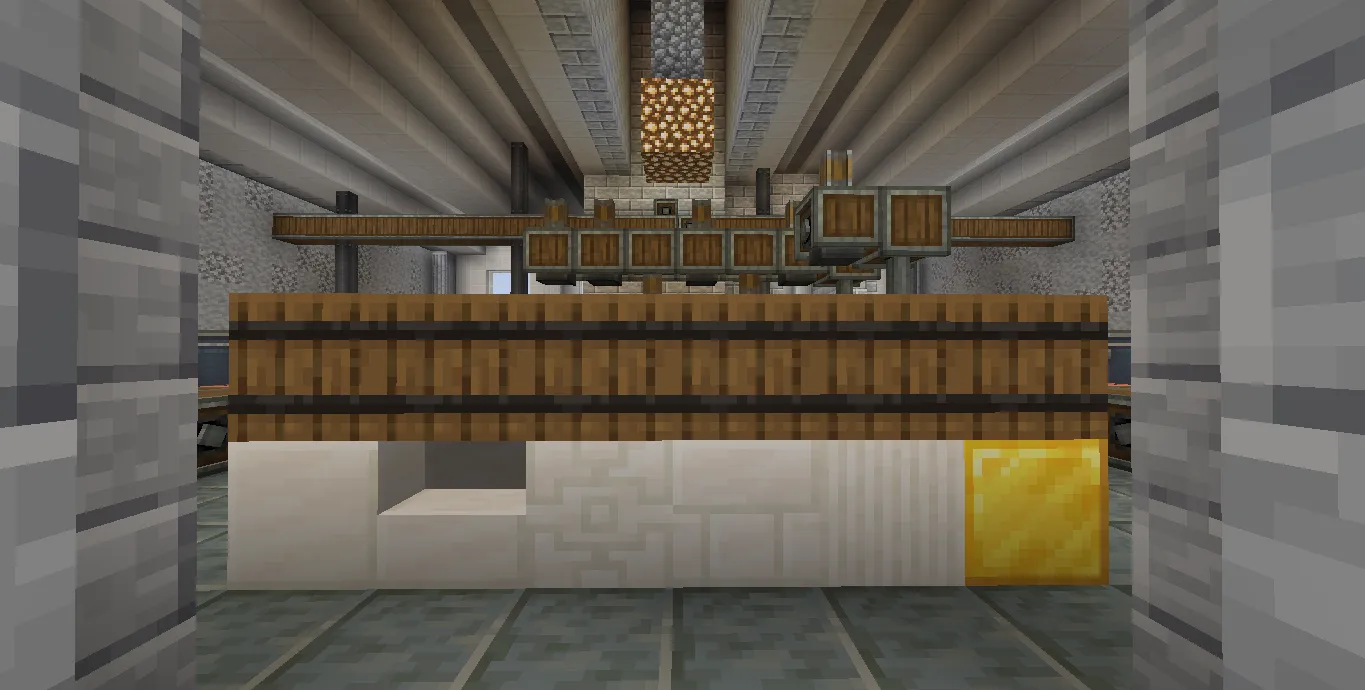 Display board showcasing various quartz blocks and a solid gold block inside a factory