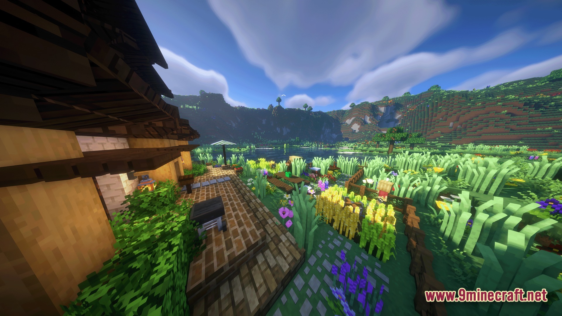 Cozy Zen Modpack Screenshot 8 A rustic wooden house overlooks a lush garden and a scenic lake surrounded by green hills
