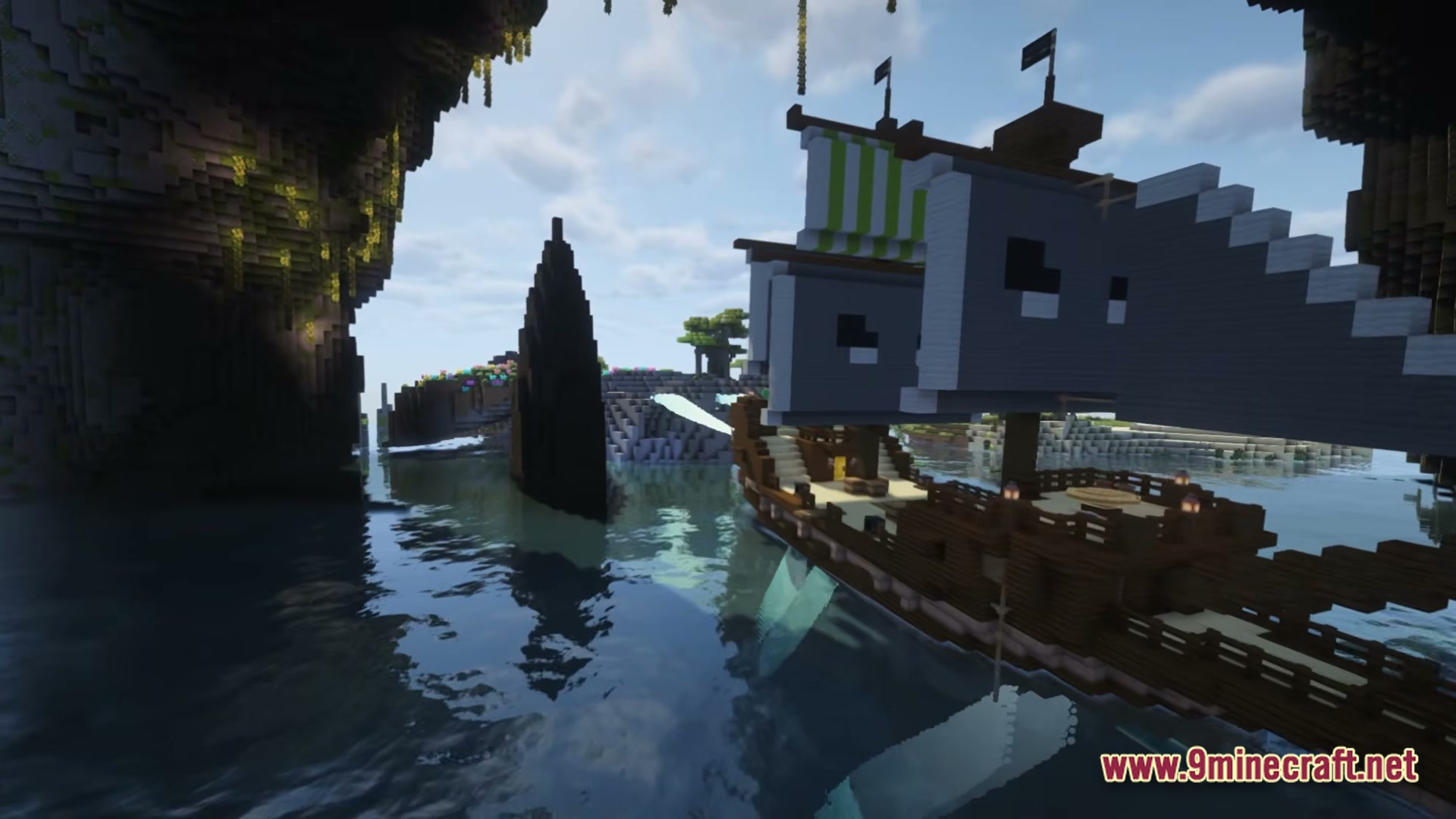 Create Aeronautica Modpack Screenshot 6 A large wooden airship with grey sails floats near a rocky cave entrance over water