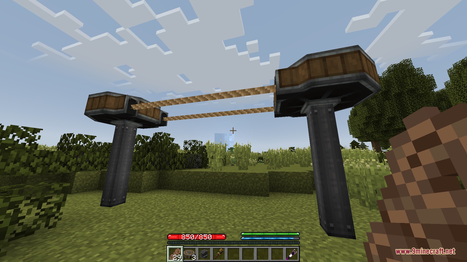 Create Chain Conveyors Compat Mod Screenshot 6 Player holding a rope item near two industrial chain conveyor pillars