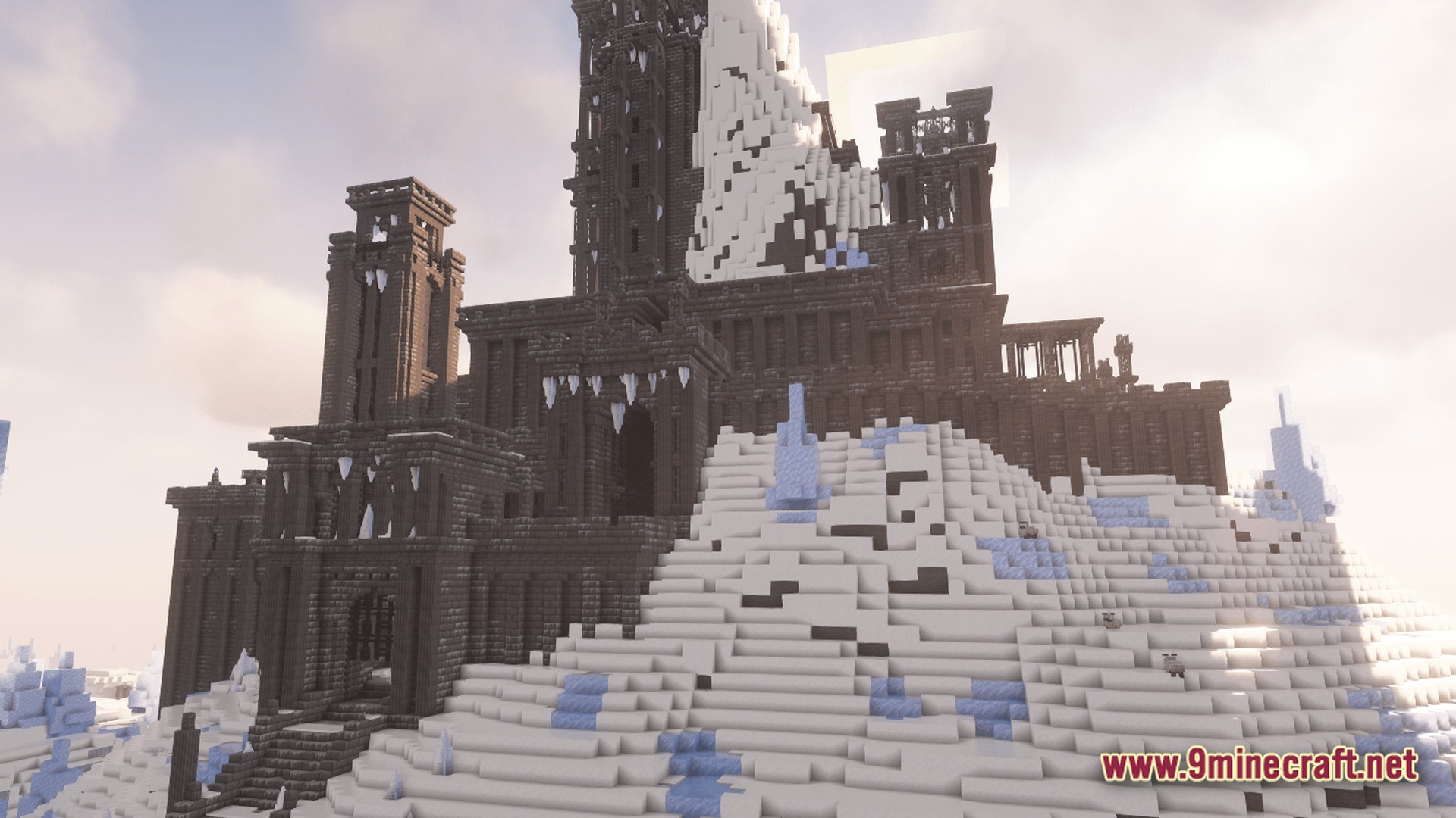 Create Forge Frontier Modpack Screenshot 8 A large dark stone fortress with icicles built into a snowy mountain peak under a bright sky